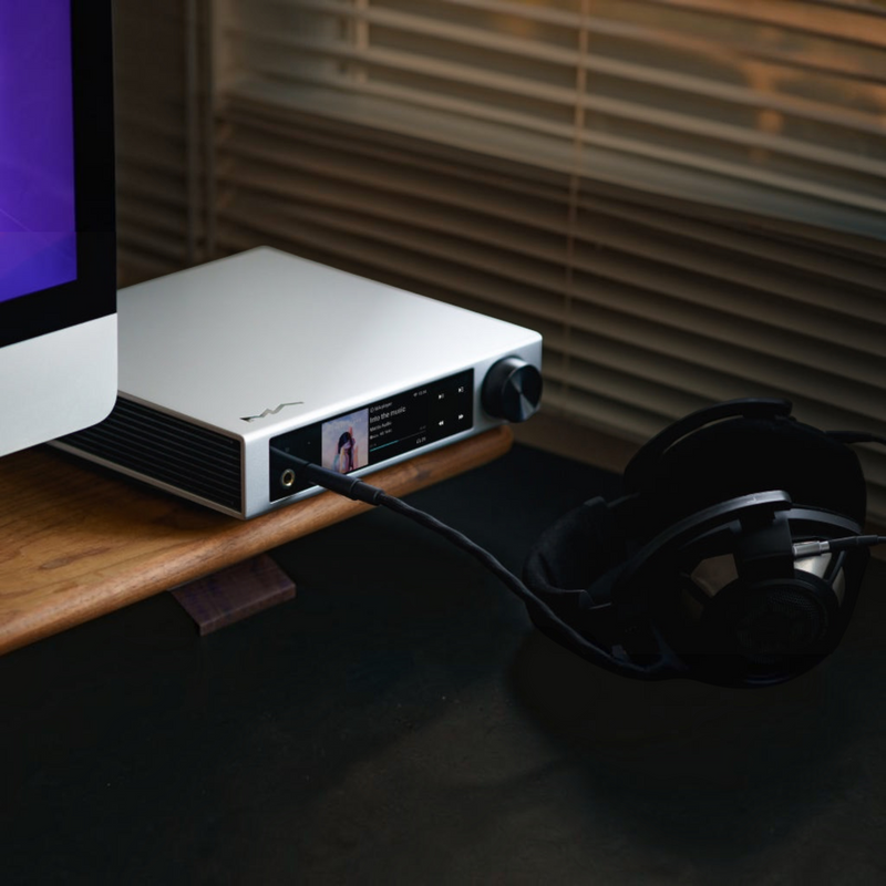 Undentia AB Matrix Audio Element i2 music streamer with LCD screen, headphone jack, and black headphones on a desk