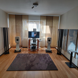 Undentia AB Genelec 8351B white active three-way studio monitors on stands in a home audio setup