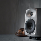 Undentia AB Genelec G Three active speaker in raw aluminum finish with a compact, curved design on a desk.