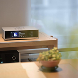 Undentia AB Matrix Audio TT-1 digital transport with display screen on a wooden shelf in a home audio setup