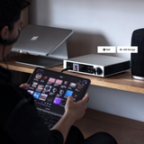 Undentia AB Element i2 music streamer with touch screen display, controlled via tablet on a wooden desk.
